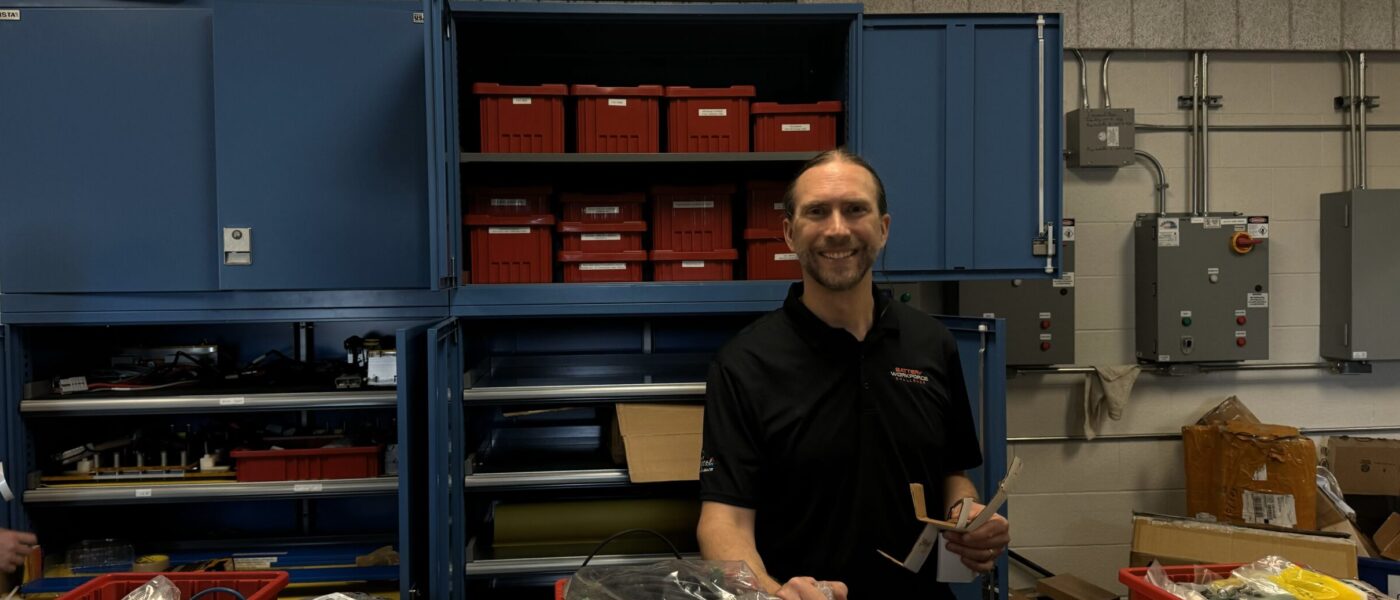 Dr. Kollmeyer at a lab cleanup day, with items organized inside boxes on top of a desk