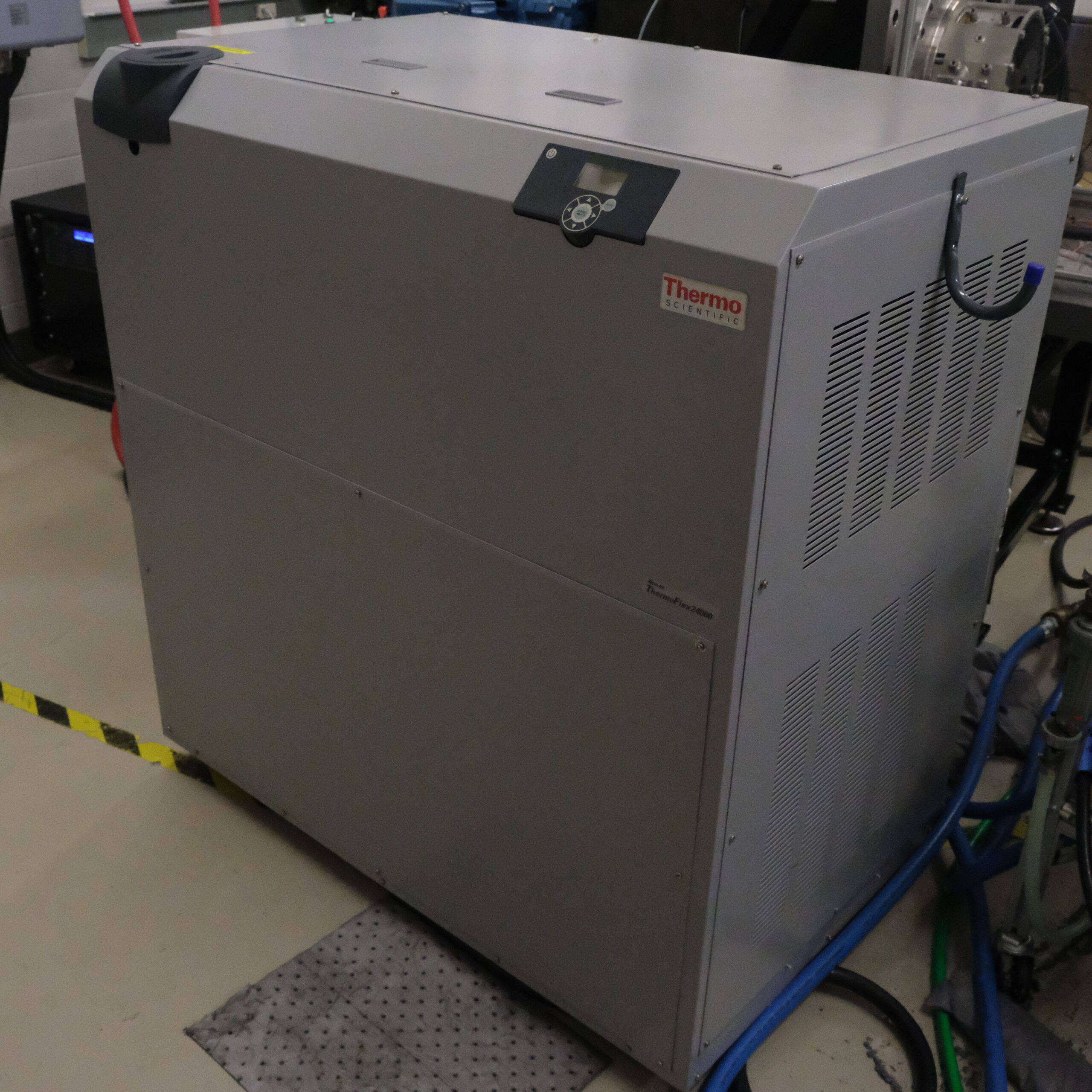 ThermoFisher liquid chiller unit, a large gray industrial machine with vents and control panel, used for cooling applications in the lab.