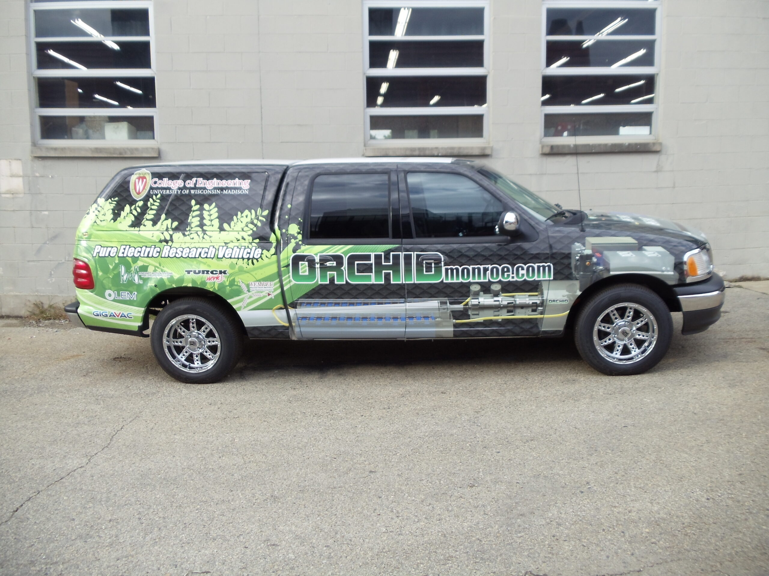 Final image of the converted Ford F150 vehicle, with a vinyl wrap that includes an image of the mechanical CAD design